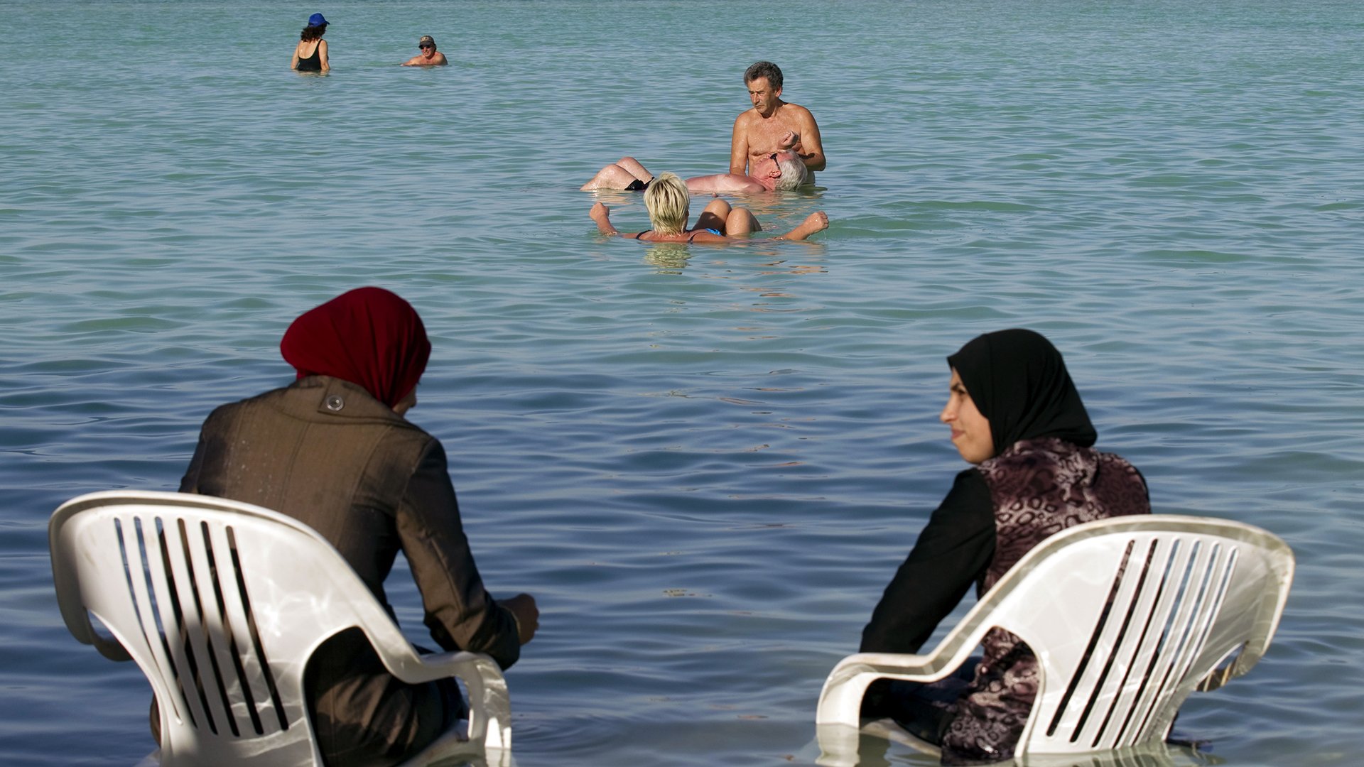 Купания страна. Грозненское море. Мусульманка на море. Мусульманки на пляже. Арабские женщины купаются в море.